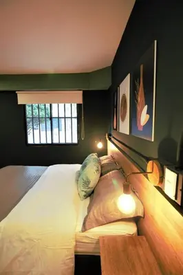 a bedroom with a large white bed and a window at Apartamento doble con baño privado y Wifi -ONE101 By Roots Rentals in Medellín