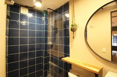 a bathroom with a shower and a mirror at Apartamento doble con baño privado y Wifi -ONE101 By Roots Rentals in Medellín
