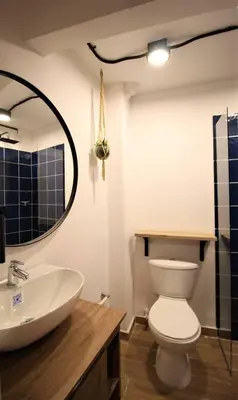 a bathroom with a sink and a toilet and a mirror at Apartamento con puesto de trabajo ONE102 By Roots Rentals in Medellín