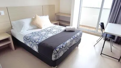 a bedroom with a bed and a window at Hotel Las Olas Bello in Machado