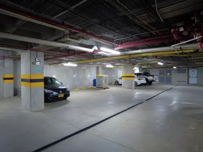 a parking garage with two cars parked in it at Hotel Las Olas Bello in Machado