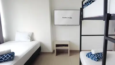a small room with two beds and a ladder at Hotel Las Olas Bello in Machado