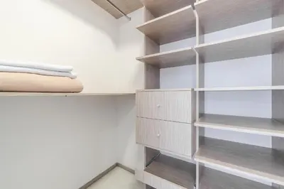 a bedroom with wooden shelves and a bed at PORTANOVA Suites by ADVENTU in Rionegro