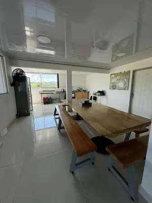 a room with a large wooden table and benches at La Martina Palestina in Palestina
