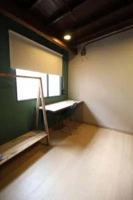 a room with a window and a table and a chair at Estudio sector Universidad de Medellín - ONE205 By Roots Rentals in Medellín