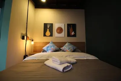 a bedroom with a bed with two towels on it at Estudio sector Universidad de Medellín - ONE205 By Roots Rentals in Medellín