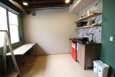 a kitchen with a counter and a sink in a room at Estudio sector Universidad de Medellín - ONE205 By Roots Rentals in Medellín