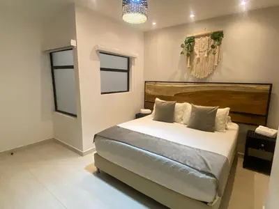 a bedroom with a large bed in a room at Maidy Luxury Hotel in Medellín