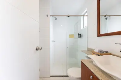 a bathroom with a shower and a toilet and a sink at Central, Fast WiFi, AC and Poblado Views in Medellín