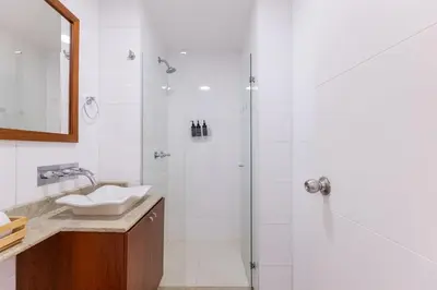 a bathroom with a shower and a sink at Central, Fast WiFi, AC and Poblado Views in Medellín