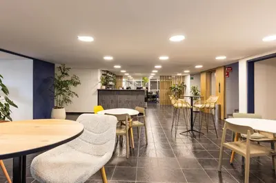 a restaurant with tables and chairs and a counter at Central, Fast WiFi, AC and Poblado Views in Medellín