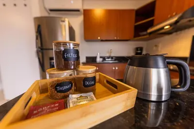a wooden tray with food on a kitchen counter at Central, Fast WiFi, AC and Poblado Views in Medellín