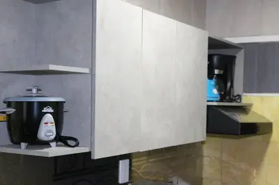 a kitchen with a coffee pot on a shelf at Hermosa casita cerca al centro in Medellín