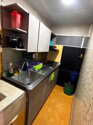 a small kitchen with a sink and a stove at Hermosa casita cerca al centro in Medellín