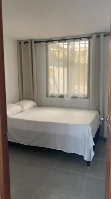 a bed in a room with a window at Casa linda San Carlos in San Carlos