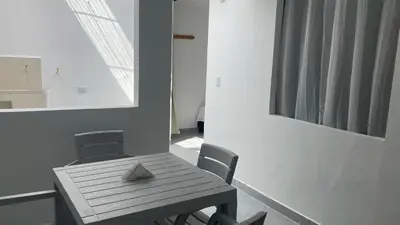 a wooden table and chairs in a room at Casa linda San Carlos in San Carlos