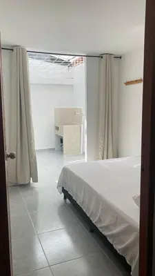a bedroom with a bed and a table in a room at Casa linda San Carlos in San Carlos