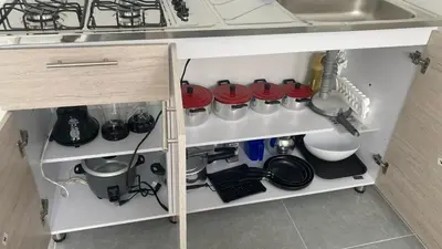 a kitchen cabinet filled with lots of kitchen utensils at Casa linda San Carlos in San Carlos