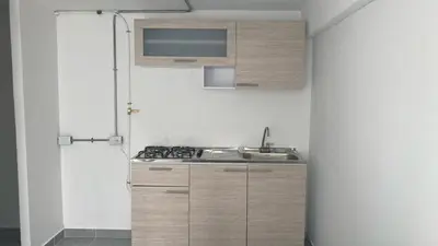 a kitchen with a sink and a stove top oven at Casa linda San Carlos in San Carlos