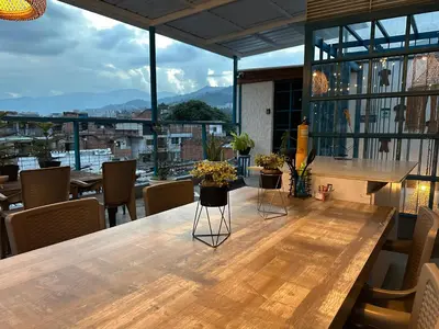 a table in a room with a view of a city at Hotel Casa Lucca in Medellín