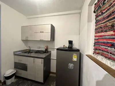 a small kitchen with a sink and a refrigerator at Hotel Casa Lucca in Medellín