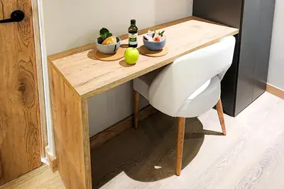 a table with two bowls of fruit and a bottle of beer at Las Lomas Luxury House2 in Medellín