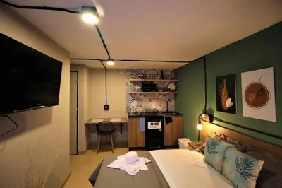 a small room with a bed and a kitchen at Apartamento privado con patio interno ONE103 By Roots Rentals in Medellín