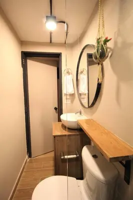 a bathroom with a toilet and a sink and a mirror at Apartamento privado con patio interno ONE103 By Roots Rentals in Medellín