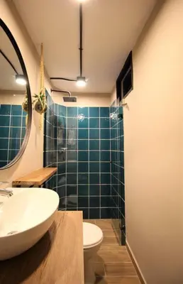 a bathroom with a sink and a toilet and a mirror at Apartamento privado con patio interno ONE103 By Roots Rentals in Medellín