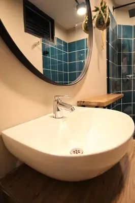 a white sink in a bathroom with a mirror at Apartamento privado con patio interno ONE103 By Roots Rentals in Medellín