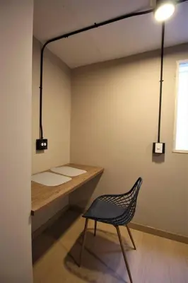 a room with a desk and a chair in it at Apartamento cerca Universidad Medellín ONE104 By Roots Rentals in Medellín