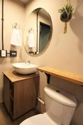 a bathroom with a sink and a toilet and a mirror at Apartamento cerca Universidad Medellín ONE104 By Roots Rentals in Medellín