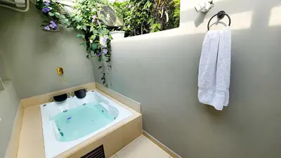 a bathroom with a bath tub with a sink at Luxury Villa In Aguacatala2 in Medellín