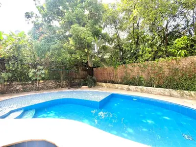 a swimming pool in a backyard with a fence at Luxury Villa In Aguacatala2 in Medellín