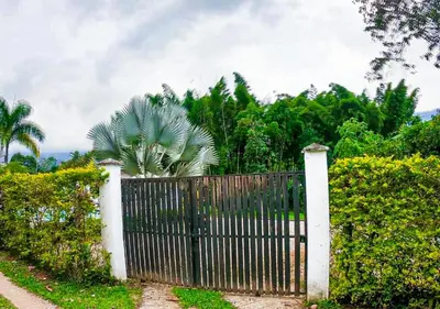 a fence with a wooden gate in front of a garden at Finca Turística Peñoles - Cerca de Charcos y Cascadas - Finca Rústica en San Carlos, Antioquia in San Carlos