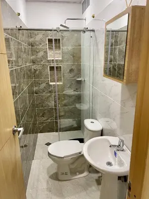 a bathroom with a toilet and a sink and a shower at HOTEL TORRE DELUXE ¨SANTORINI¨ in Doradal