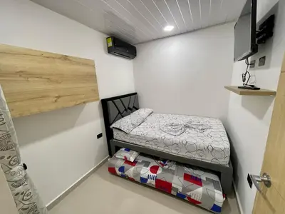 a small bedroom with a bed in a room at HOTEL TORRE DELUXE ¨SANTORINI¨ in Doradal