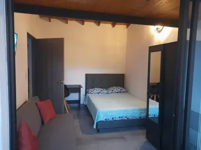 a bedroom with a bed and a mirror at Gorgeous Penthouse Apartment in Medellin in Medellín