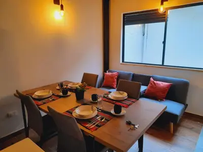 a dining room with a table and a couch at Gorgeous Penthouse Apartment in Medellin in Medellín