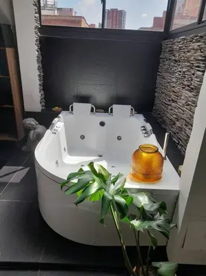a white bath tub in a bathroom with a plant at Gorgeous Penthouse Apartment in Medellin in Medellín