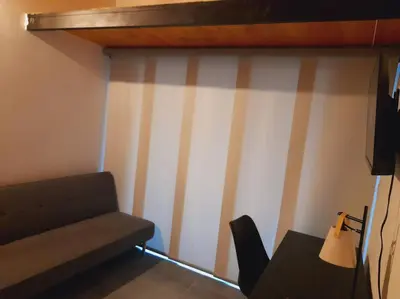 a room with a couch and a table with a chair at Gorgeous Penthouse Apartment in Medellin in Medellín