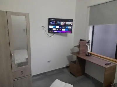 a room with a tv on the wall and a desk at Gorgeous Penthouse Apartment in Medellin in Medellín