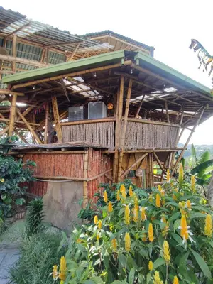 a building with a deck with yellow flowers at El Turpial in Jericó