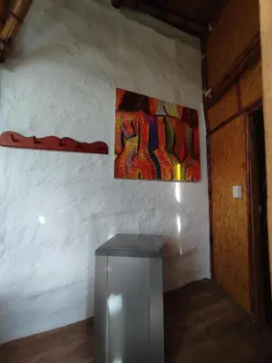 a room with a wall with a painting on the wall at El Turpial in Jericó