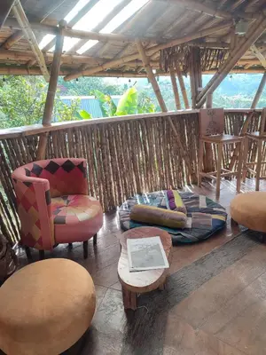 a porch with chairs and a couch and a table at El Turpial in Jericó