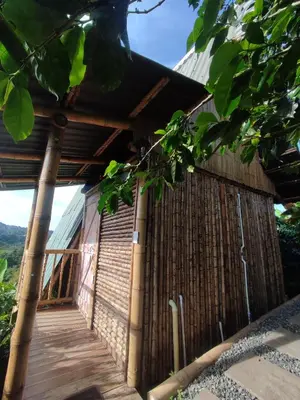 a bamboo building with a wooden walkway at El Turpial in Jericó