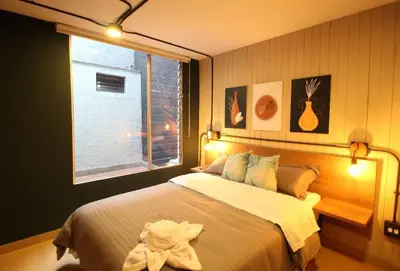 a bedroom with a large bed and a window at Apartamento que permite mascota en Medellín ONE105 By Roots Rentals in Medellín