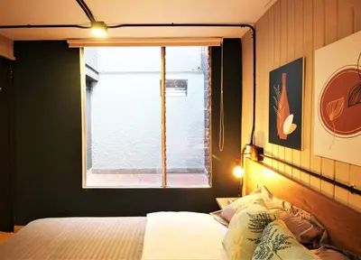 a bedroom with a bed with a window and a bed sidx sidx sidx at Apartamento que permite mascota en Medellín ONE105 By Roots Rentals in Medellín
