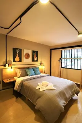 a bedroom with a large bed with a flower on it at Apartamento con cocina y baño privado - ONE106 By Roots Rentals in Medellín