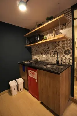 a kitchen with a sink and two trash cans at Apartamento con cocina y baño privado - ONE106 By Roots Rentals in Medellín